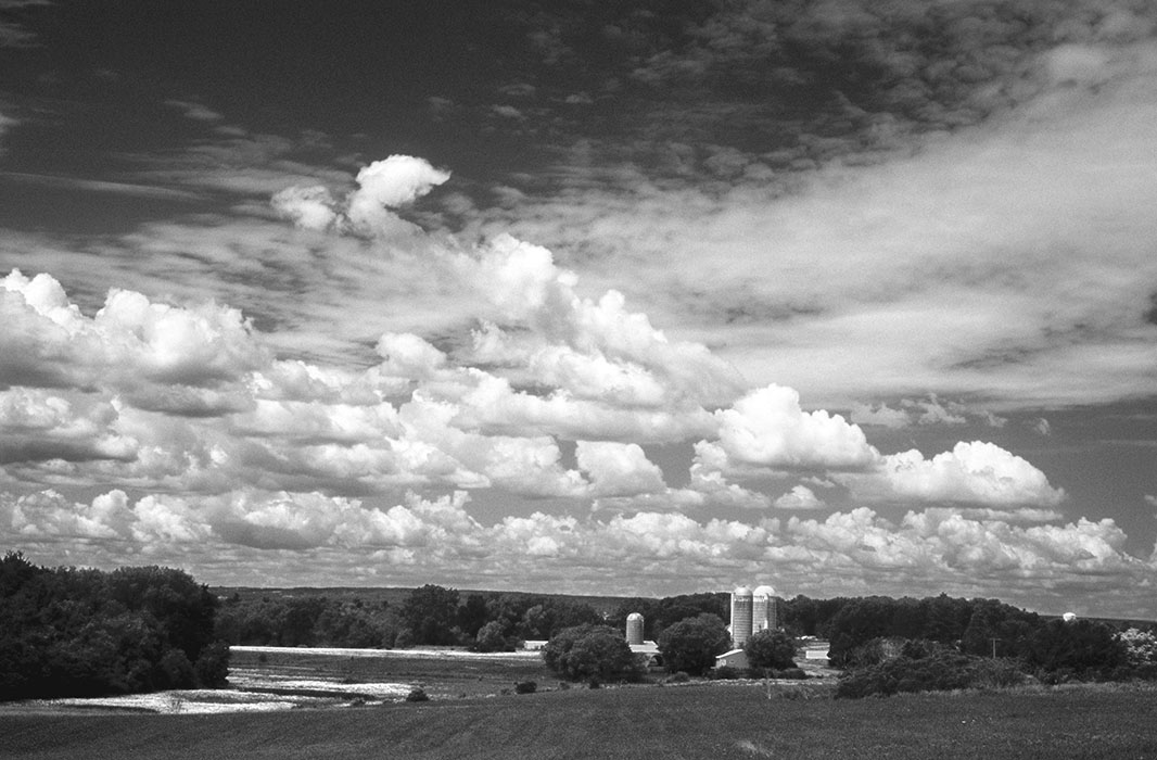 Rounded clouds and silo tops