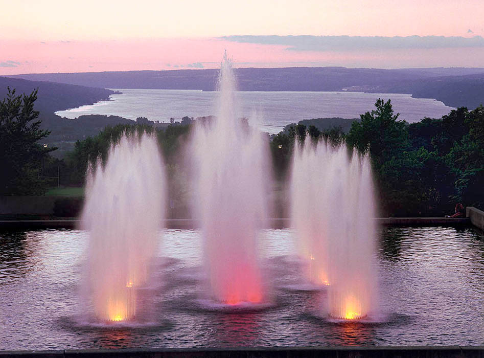 Fountains at Ithaca College with Cayuga Lake in the background