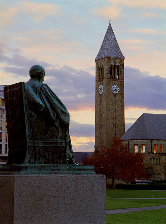 White's statue and a pumpkin decorated McGraw Tower, Cornell U.